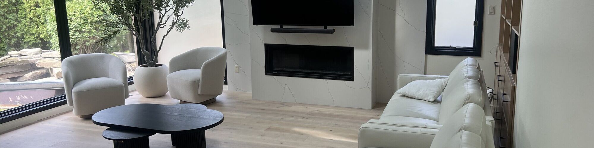 A contemporary living space with a stone feature wall