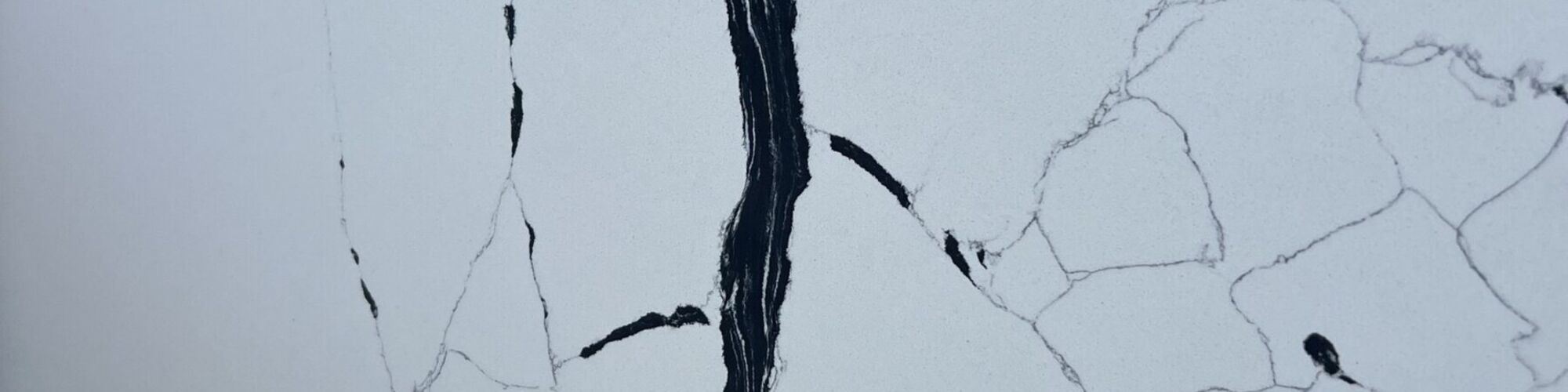 A white quartz slab with fine consistent veining