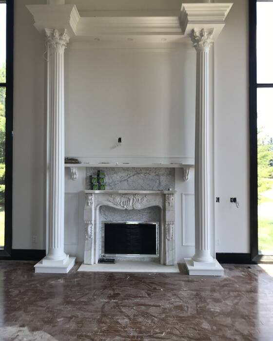 Stone fireplace surround fabricated by Beautiful Granite & Marble