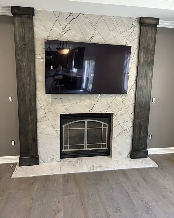 Stone fireplace surround fabricated by Beautiful Granite & Marble