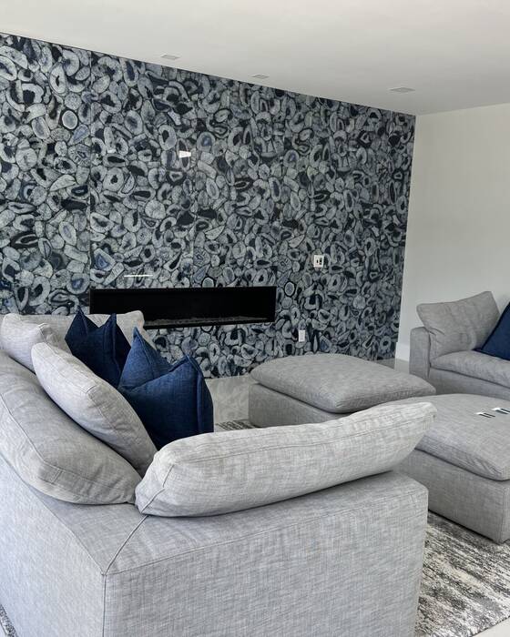 Stone fireplace surround fabricated by Beautiful Granite & Marble